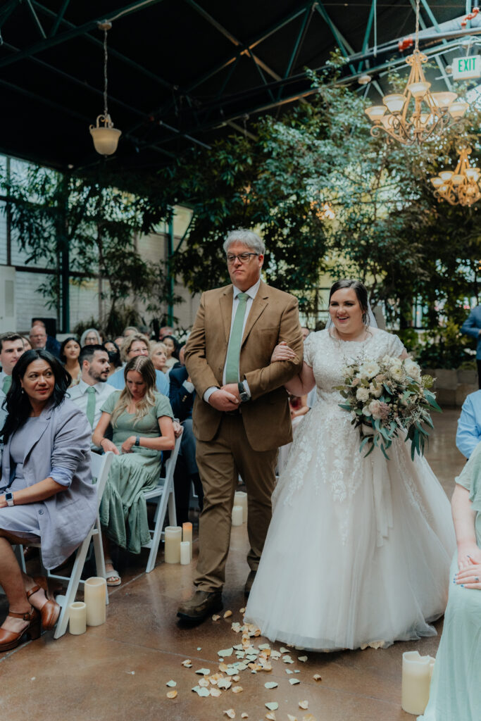Bride and father-of-bride walking down the aisle at wedding
