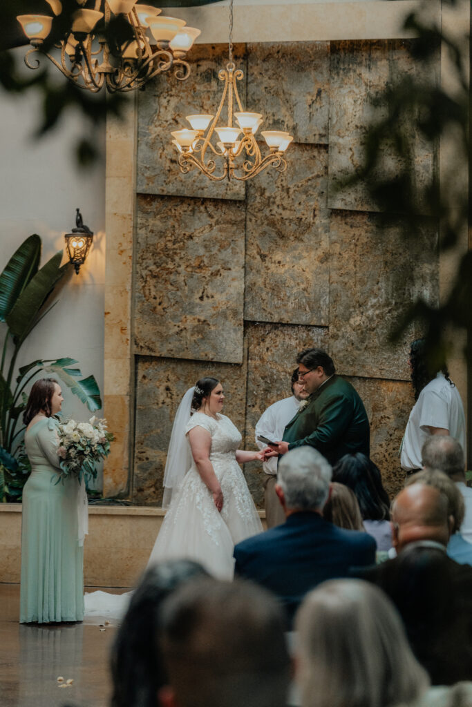 Bride and groom exchanging vows at wedding photographed by Love Lalee Photography